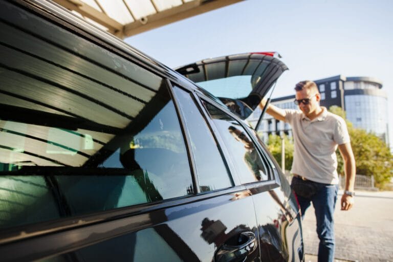 man-lifting-trunk-door-black-car